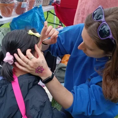 Casey face painting Meadows Festival